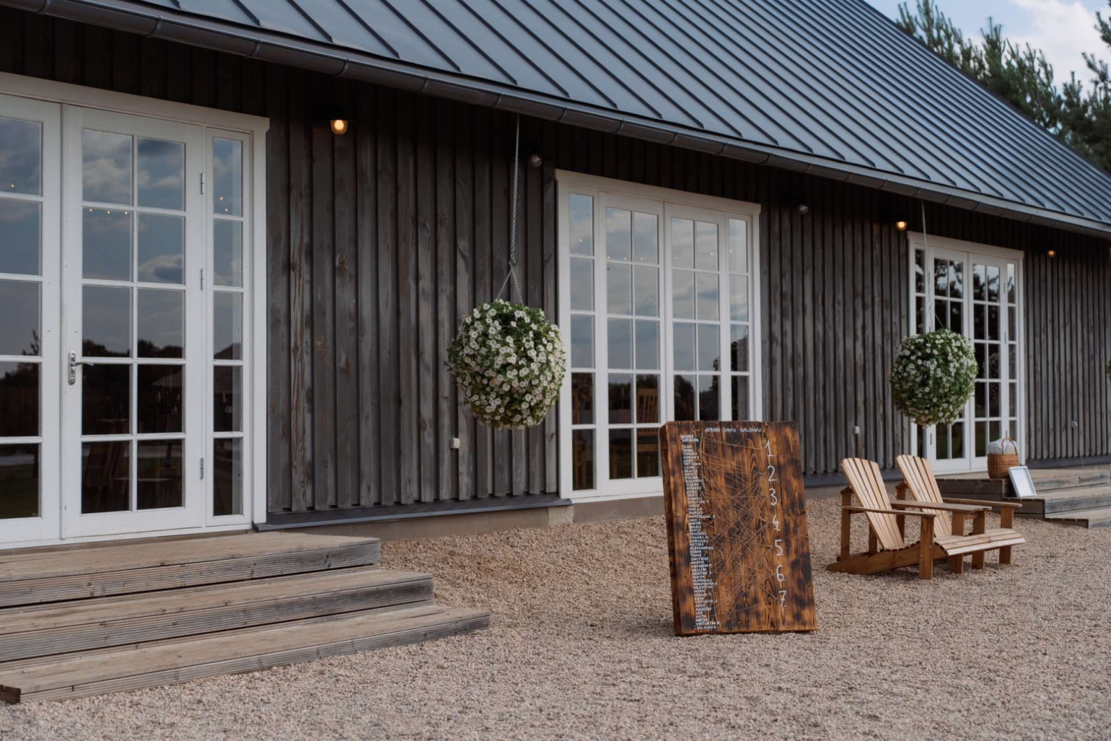 Ēkas ieeja ar 3 baltiem logiem/durvīm